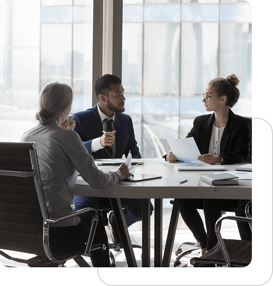 Three professionals engaged in a business meeting around a table.
